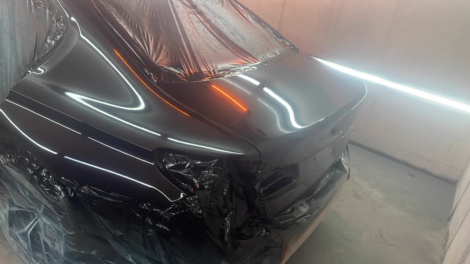 Freshly painted black rear panel with a high gloss finish