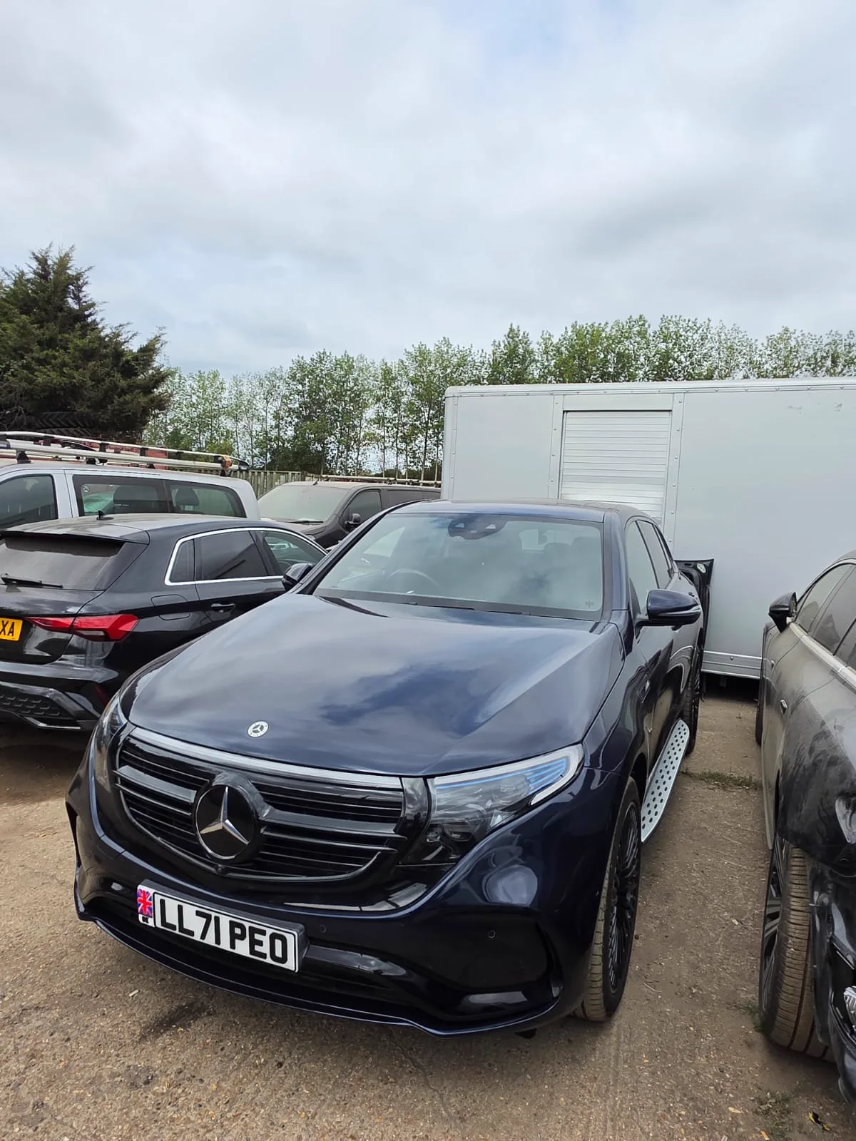 Repaired dark blue Mercedes EQC seen from the front