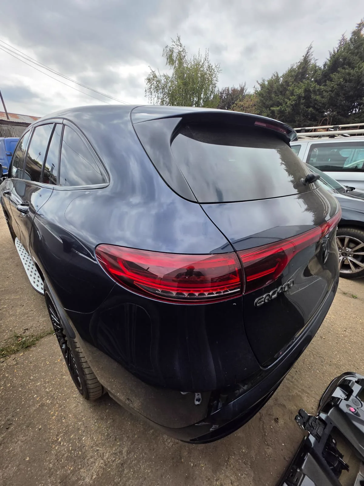 Repaired dark blue Mercedes EQC seen from the rear
